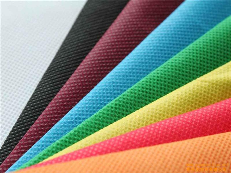 What is the most commonly used fiber to produce spunbond nonwoven fabrics?
